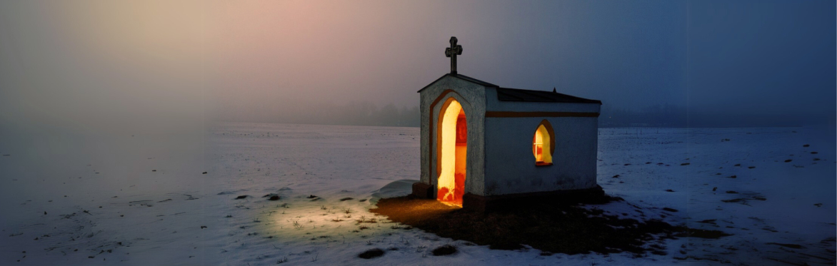 A snow covered track at dusk with light at the end