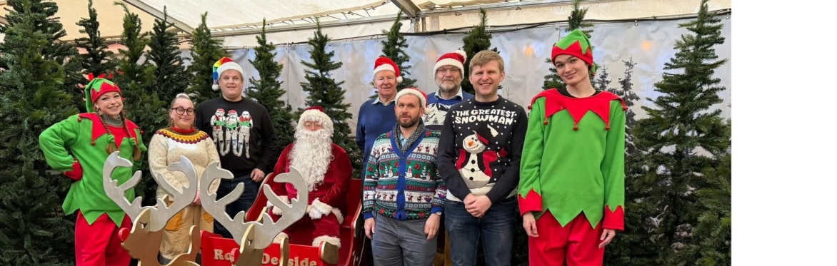 Santa and his team of elves and carol singers