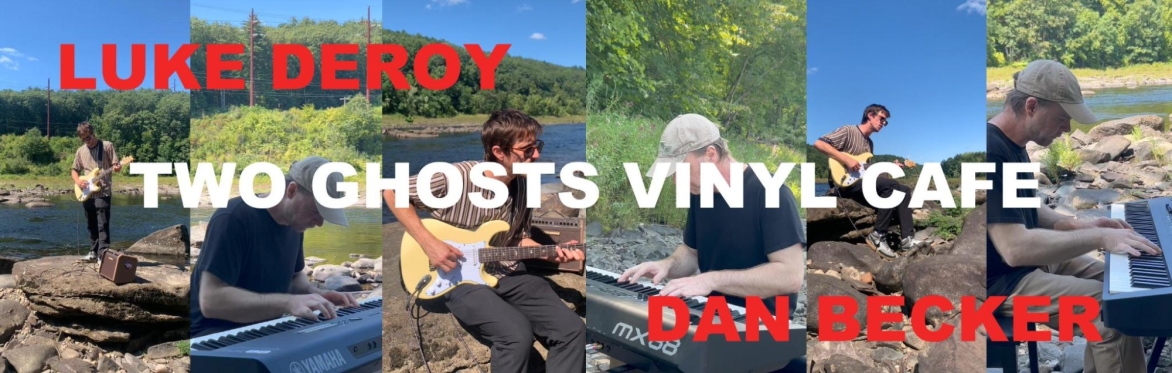 Luke Deroy playing guitar and Dan Becker playing piano on a stone riverside