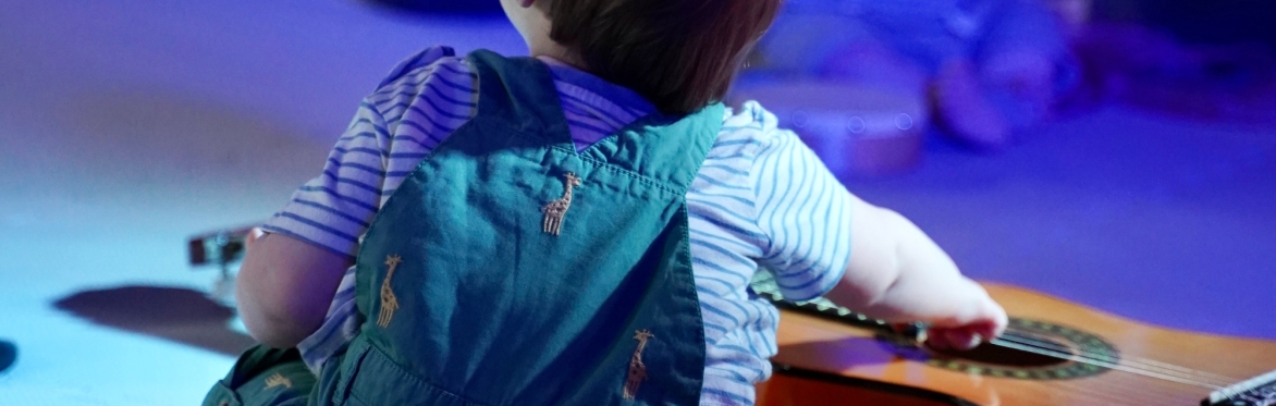 Baby listening to music at a baby concert