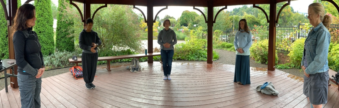 A group of Qi Gong practitioners closing their practice session
