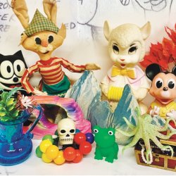 An image of assorted vintage plastic kids' toys including Felix the cat and Mickey Mouse