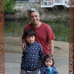Family posing within a York rivers trail heritage frame beside the river, creating a shared moment of exploration and creativity.