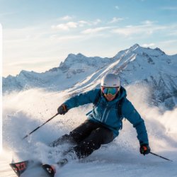 Skier carving through snow in the Bansko mountains during a Takeover Ski trip.
