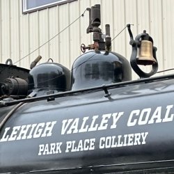The upper half of steam locomotive #123 with the whistle in the center