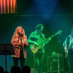 The image features Pentangle performing on stage with multi-coloured spotlights shining on them