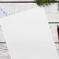 A photo of a table and a piece of paper that represents the christmas appeal, as well as baubles that are christmas decorations