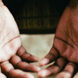 Opened hands in prayer and surrender to God
