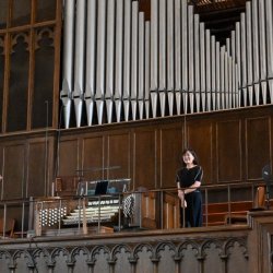 Marianne Kim in front of the organ at Second Presbyterian Church