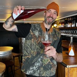 Head winemaker Adam pouring wine