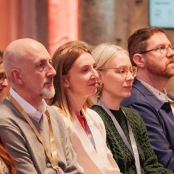 People sat listening to a session at an NPC event