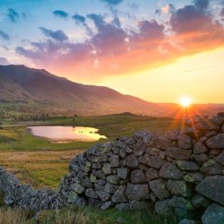 Beautiful image of sunset on a waterbody with a mountain behind