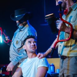 A man in an improv scene is pulled over by the cops