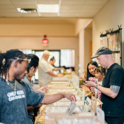 Someone crate digging through records