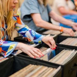 Someone crate digging through records