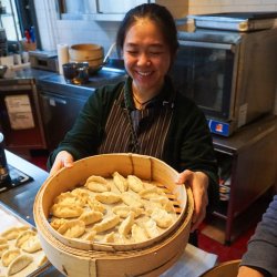 Dumpling Class Teacher Xiaowu with freshly steamed Dumplings (Jiaozi) made by Participants