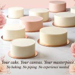 Ten ivory ganache covered celebration cakes displayed on white cake boards across a marble table, ready to be decorated, with a small bouquet of pink and cream roses in the background.
