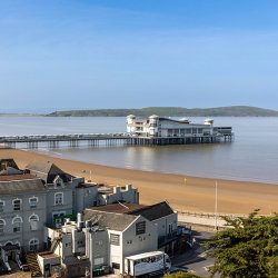 Weston Super Mare. Looking at the Grand Pier, on a sunny day, with Brean Down  in the background