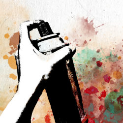 A b&w image of a hand spraying a can of paint