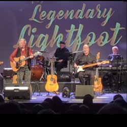 Chris Scott and some members of the Whozat Band peforming on stage
