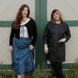 Two women in front of barn doors