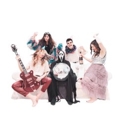 5 performers in party-style outfits celebrate on a sofa around a central figure dressed as death, wearing a black cloak and holding a disco ball.