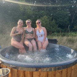 girls in a hot tub with sunglasses and swimsuits
