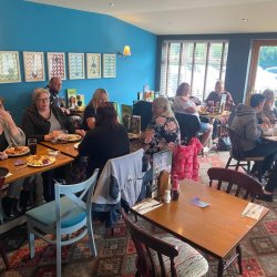 People sat having lunch smiling