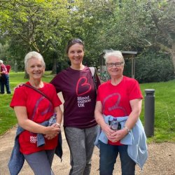 Three supporters doing Glasgow Walk
