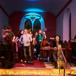 This image is of people singing and playing music onstage in St. Mary's Church Leixlip