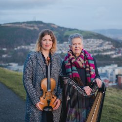 Angharad Jenkins with fiddle next to her mother Delyth Jenkins with harp