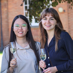 Two festivalgoers smile with champagne flutes at the JAM festival opening reception.