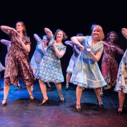 Women smiling and dancing.
