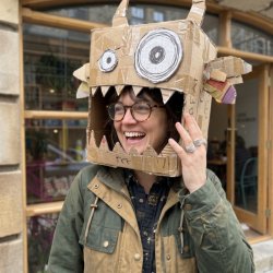 Woman wearing a cardboard beast on head