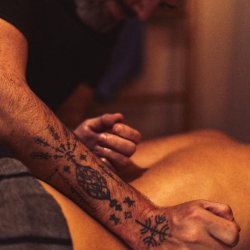Bear's hands massaging someone's back