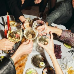 People cheers-ing glasses of wine