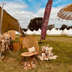 Hot tubs, sauna and seating in a field