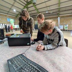 Youngsters engrosed in repairing things.