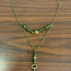 A variety of spherical gemstone beads on a string.