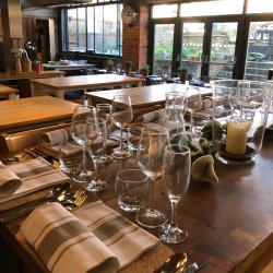 Table laid for dinner with glassware and cutlery in a cookery school