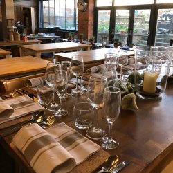 Table laid for dinner with glassware and cutlery in a cookery school