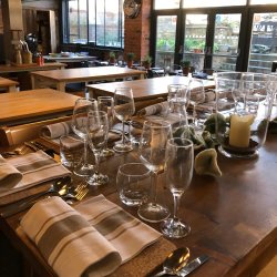 Table laid for dinner with glassware and cutlery in a cookery school