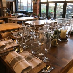 Table laid for dinner with glassware and cutlery in a cookery school