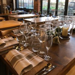 Table laid for dinner with glassware and cutlery in a cookery school