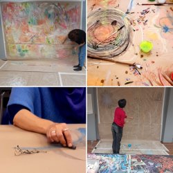 people drawing at a table and on a wall
