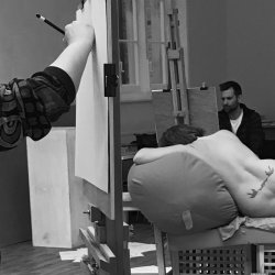 Photo of life drawing group with back of model