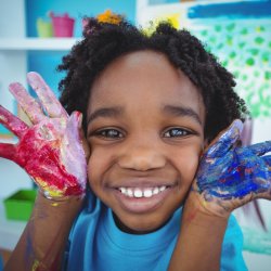 Photo of kid with paint on hands
