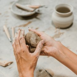 Photo of person's hands shaping clay