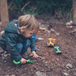 toddler playing in dirt