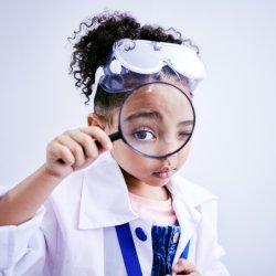 Photo of kid with magnifiying glass